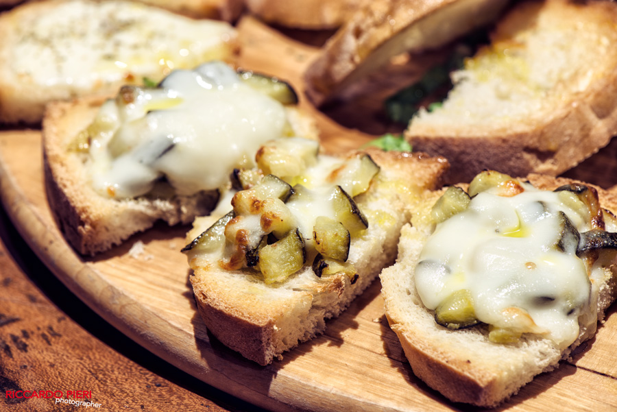  an assorted Bruschetta plate with melted cheese